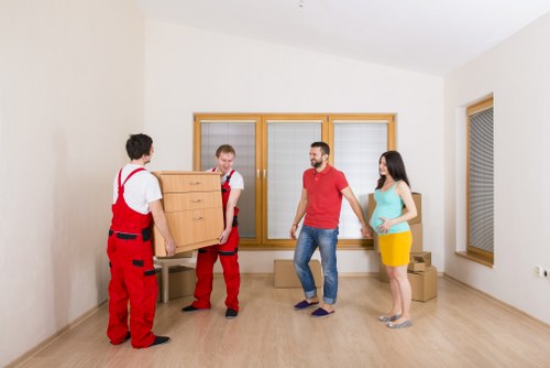Boxes and furniture being loaded into a moving truck