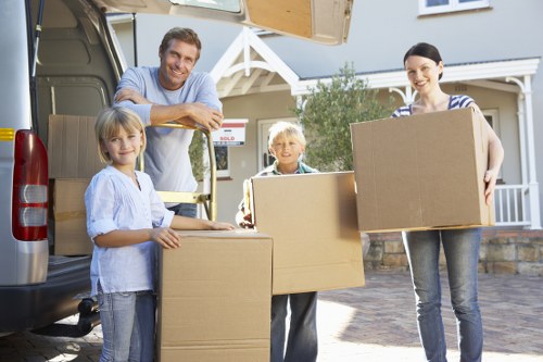 Removal team loading household items into a van