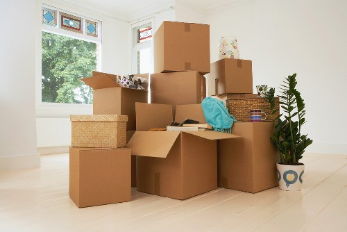 Mover wearing PPE while handling items in New Malden